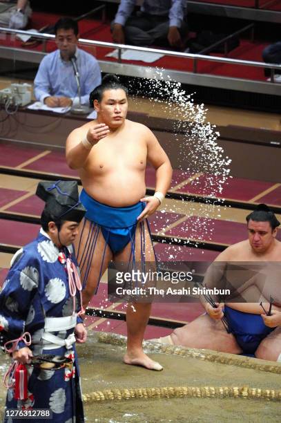 Toyoshoryu sprinkles salt ahead of his bout against Tokushoryu on day eleven of the Grand Sumo Autumn Tournament at Ryogoku Kokugikan on September...