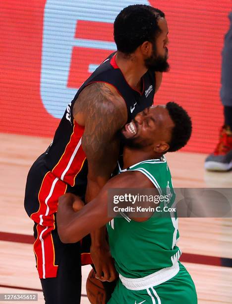 Kemba Walker of the Boston Celtics draws a foul against Andre Iguodala of the Miami Heat during the second quarter in Game Four of the Eastern...