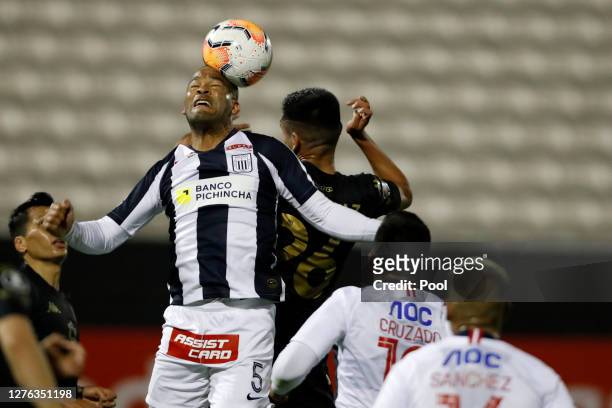 Alberto Junior Rodríguez Valdelomar of Alianza Lima heads the ball during a Group F match between Alianza Lima and Racing Club as part of Copa...