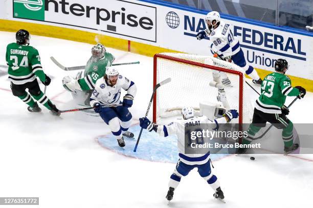 Brayden Point of the Tampa Bay Lightning is congratulated by Ondrej Palat after scoring a goal past Anton Khudobin of the Dallas Stars during the...