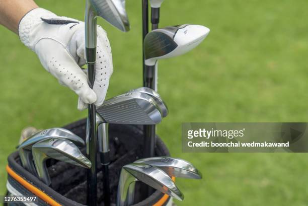 men's hands with golf clubs and clubs - golf club stock pictures, royalty-free photos & images