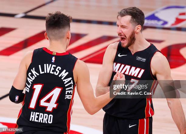 Tyler Herro of the Miami Heat and Goran Dragic of the Miami Heat react after their win over the Boston Celtics in Game Four of the Eastern Conference...