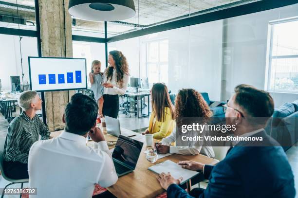 businesswoman and her daughter on a business meeting. - children looking graph stock pictures, royalty-free photos & images