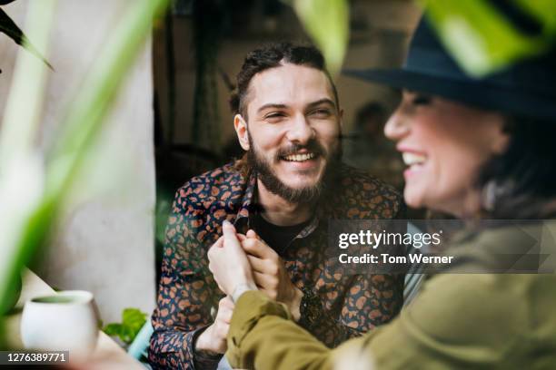 couple holding hands after meeting i cafe - plant stem stockfoto's en -beelden