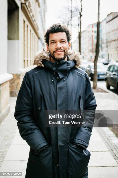 portrait of man wearing parka - winter coats stockfoto's en -beelden
