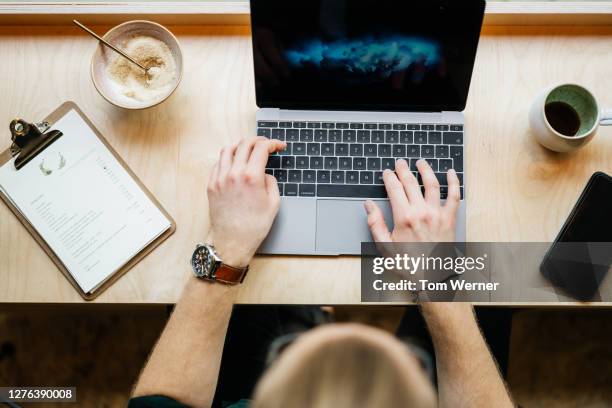 aerial view of man working on laptop in café - 21 & over stock pictures, royalty-free photos & images