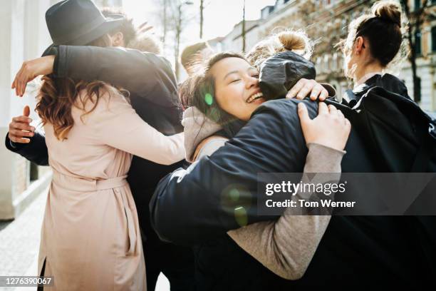 group of friends hugging in street - vietnamese ethnicity foto e immagini stock