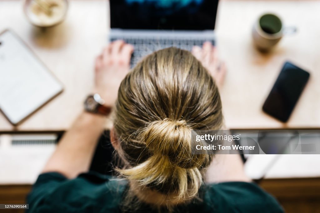 Aerial View Of Man Using Laptop In Cafe