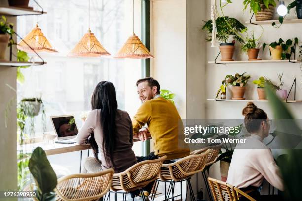 quirky café with lots of plants - busy cafe stock-fotos und bilder