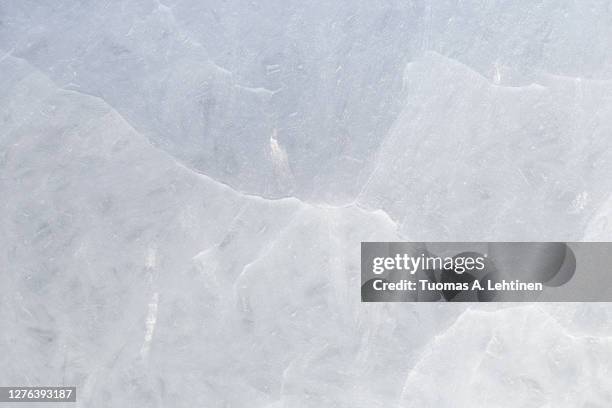 close-up of cracked ice on a frozen lake in the winter, viewed from above. - is bildbanksfoton och bilder