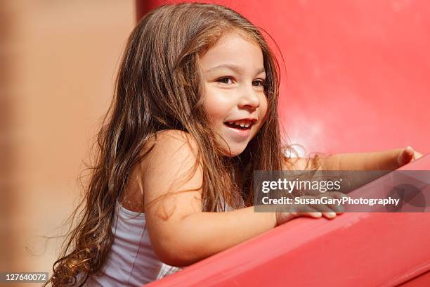 toddler girl climbing up red slide - henderson   nevada stock pictures, royalty-free photos & images