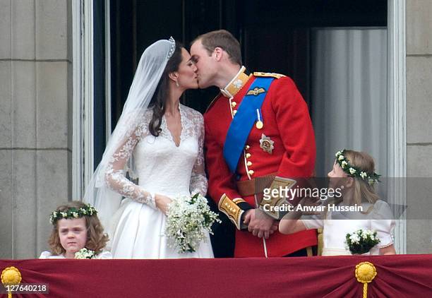 Prince William, Duke of Cambridge and Catherine Middleton, Duchess of Cambridge kiss on the balcony of Buckingham Palace following their wedding on...