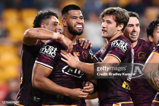 Payne Haas of the Broncos celebrates scoring a try with team mates during the round 20 NRL match between the Brisbane Broncos and the North...