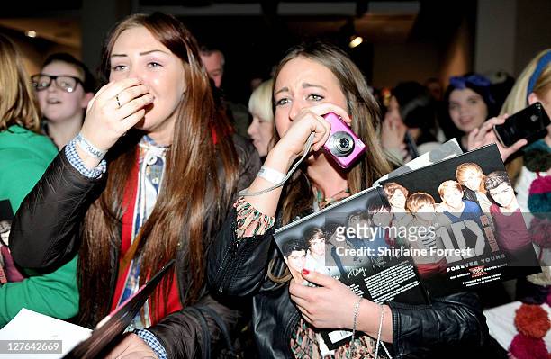 Fans attend One Direction signing their new book 'One Direction: Forever Young: Our Official X-Factor Story' at HMV on March 7, 2011 in Manchester,...