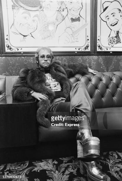 English singer and pianist Elton John poses in the bar of the London Palladium, during rehearsals for the Royal Variety Performance, UK, October 1972.