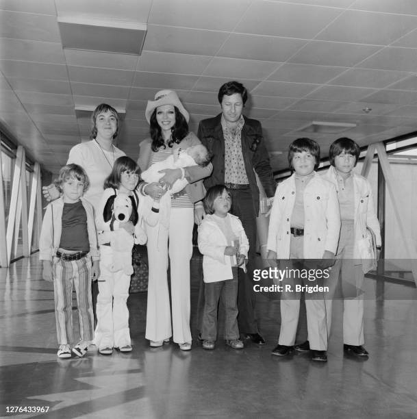 English actress Joan Collins and her husband, businessman Ron Kass with their children at London Airport, UK, 12th August 1972. Pictured are the...