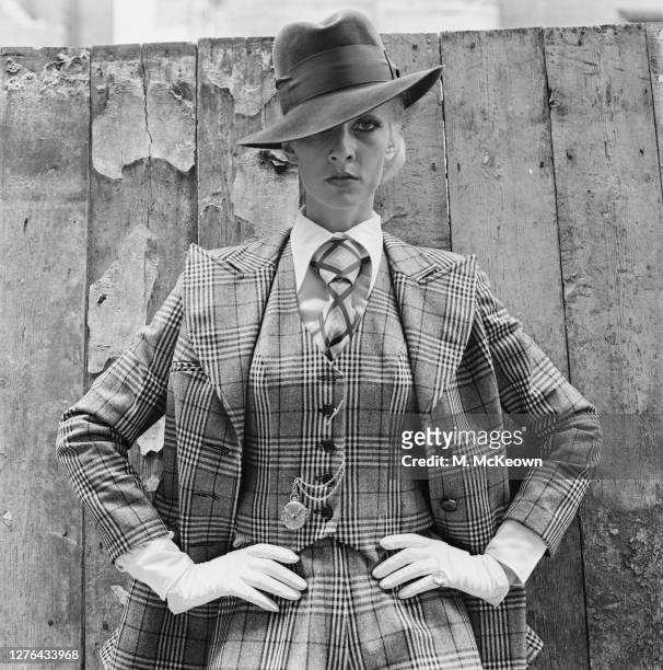 English model and actress Vicki Hodge wearing a gangster-style checked three piece suit, complete with watch chain, London, UK, 4th August 1972.