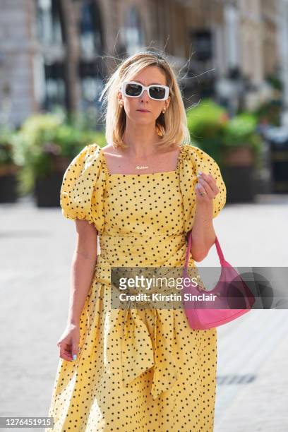 Digital Influencer Siobhan Maroney wears Versace sunglasses, Shrimps dress and a Prada bag during LFW September 2020 at on September 18, 2020 in...