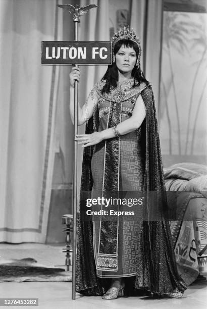 British actress Glenda Jackson holding a Roman standard with the words 'Luton FC' during the filming of a scene for 'Antony and Cleopatra', a sketch...
