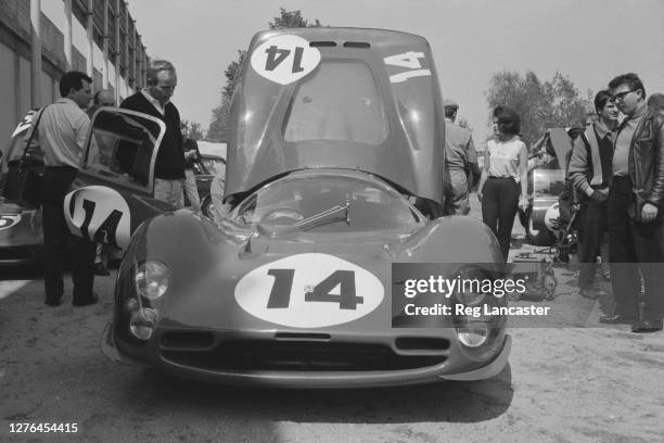 English racing driver John Surtees at Monza in Italy, with a Ferrari 330 P3 prototype, 24th April 1966. His wife Patricia is on the right.