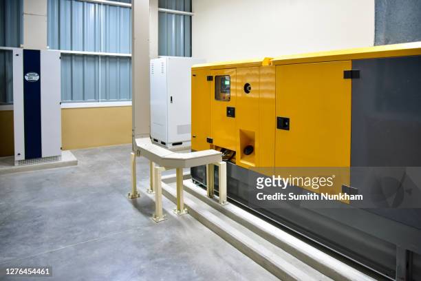 industrial generators system in the utility room standby for power backup to supply the building at factory, diesel generator - generator fotografías e imágenes de stock