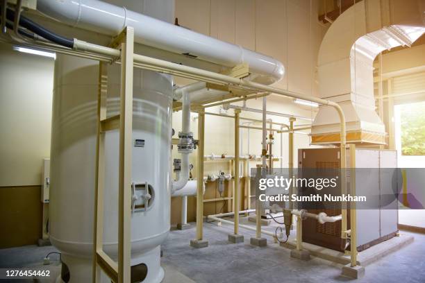 industrial air compressor systems with equipment machinary, tank, pump, gauge, valve, electric supply, and piping systems into supply manufactering process line of the factory - heat pump fotografías e imágenes de stock