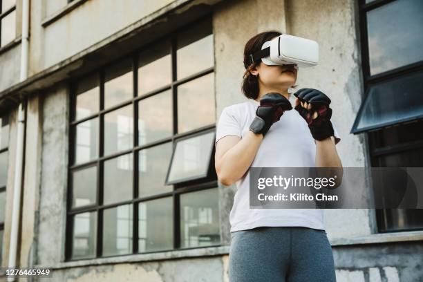 asian woman practicing boxing using vr technology - virtual window frames stock pictures, royalty-free photos & images