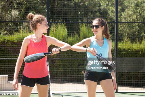 girls playing paddle tennis outdoors training - paddle tennis stock pictures, royalty-free photos & images