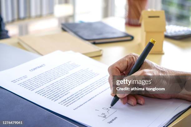 signing official document or contract. - herencia fotografías e imágenes de stock