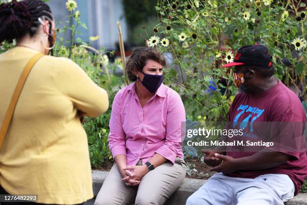 Senate candidate Amy McGrath speaks to a member of the community as she visits a makeshift memorial for Breonna Taylor on September 24, 2020 in...