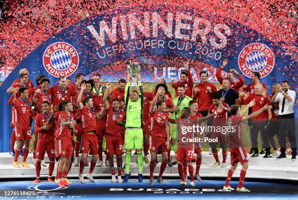 Manuel Neuer of Bayern Munich lifts the UEFA Super Cup trophy as he celebrates victory over FC Sevilla at Puskas Arena on September 24, 2020 in...