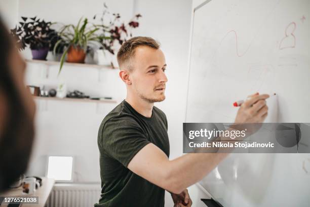 a businessman uses a whiteboard - scrum roles stock pictures, royalty-free photos & images