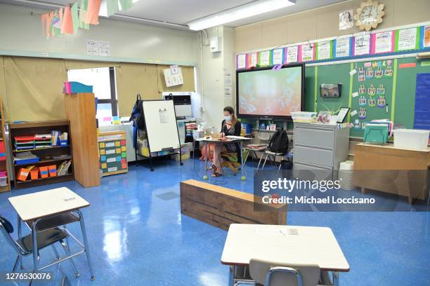 Marisa Wiezel, a teacher at Yung Wing School P.S. 124 who is related to the photographer, wears a mask and teaches remotely from her classroom on...