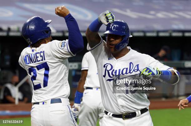 Salvador Perez of the Kansas City Royals is congratulated by Adalberto Mondesi after hitting a three-run home run during the 1st inning of the game...