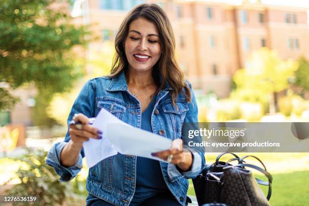 mature adult hispanic female voter with mail-in voting election ballot in western usa photo series - voting covid stock pictures, royalty-free photos & images