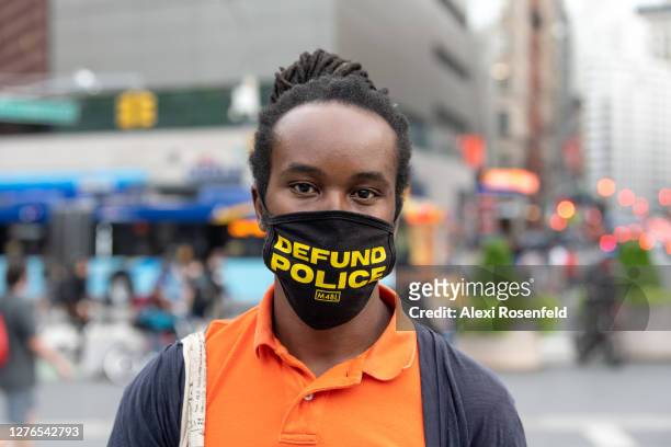 Man wearing a "defund police" mask poses in Union Square as the city continues Phase 4 of re-opening following restrictions imposed to slow the...