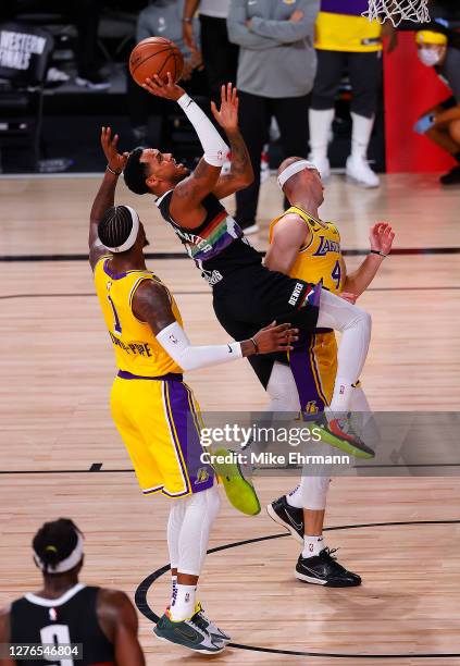 Monte Morris of the Denver Nuggets drives to the basket against Kentavious Caldwell-Pope of the Los Angeles Lakers during the third quarter in Game...