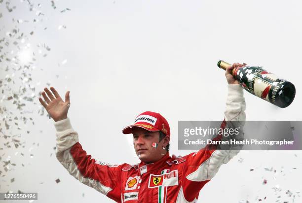 Finnish Ferrari Formula One driver Kimi Raikkonen on the podium celebrating winning the 2007 Brazilian Grand Prix held at the Autodromo José Carlos...