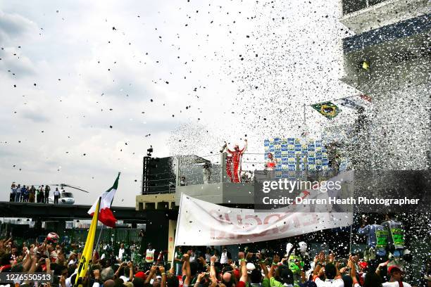 Finnish Ferrari Formula One driver Kimi Raikkonen on the podium celebrating winning the 2007 Brazilian Grand Prix held at the Autodromo José Carlos...