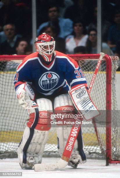 Grant Fuhr of the Edmonton Oilers defends his goal against the New Jersey Devils during an NHL Hockey game circa 1988 at the Brendan Byrne Arena in...