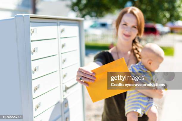 western us young mother with infant child with mail-in election ballot and mailbox photo series - mail voting stock pictures, royalty-free photos & images