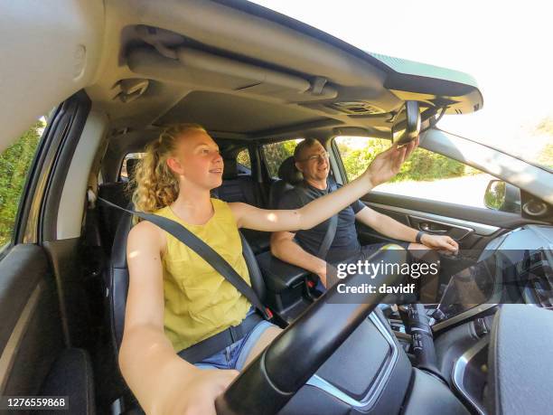 feliz adolescente aprendiendo a conducir un coche - australian family car fotografías e imágenes de stock