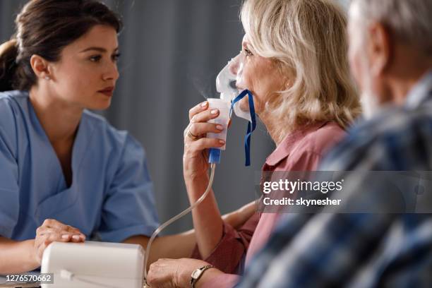 inhaling through nebulizer at doctor's office! - asthma in adults imagens e fotografias de stock