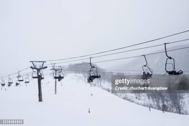 ski cable car at niseko ski resort on snow covered field, niseko, hokkaido, japan - hirafu snow resort stock pictures, royalty-free photos & images