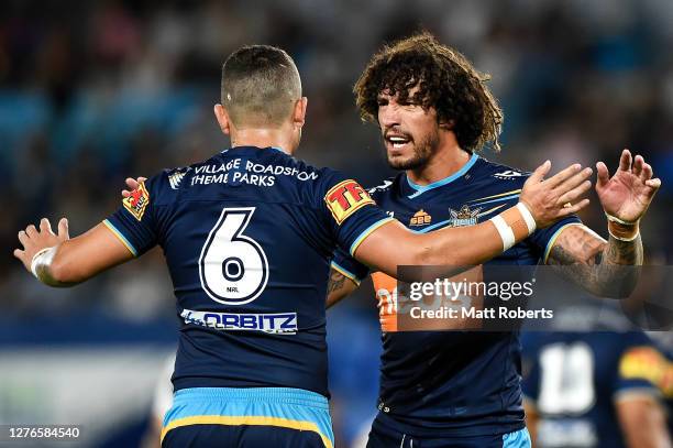 Ashley Taylor of the Titans celebrates with Kevin Proctor of the Titans during the round 20 NRL match between the Gold Coast Titans and the Newcastle...