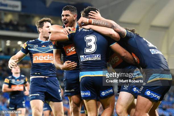 Brian Kelly of the Titans celebrates with his team mates after scoring a try during the round 20 NRL match between the Gold Coast Titans and the...