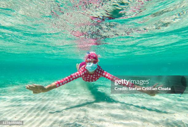 girl swimming with mask at balos beach crete - balonnen stock-fotos und bilder