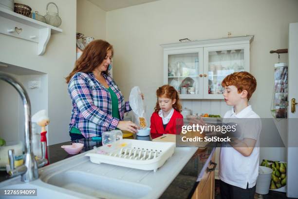getting breakfast ready before school - breakfast before school stock pictures, royalty-free photos & images