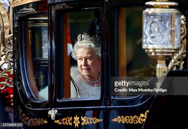 Queen Elizabeth II travels down The Mall, from Buckingham Palace to the Palace of Westminster, in the horse drawn Australian State Coach to attend...