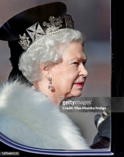 Queen Elizabeth II travels down The Mall, from Buckingham Palace to the Palace of Westminster, in the horse drawn Australian State Coach to attend...